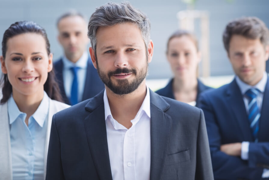 man in focus and his team in the background