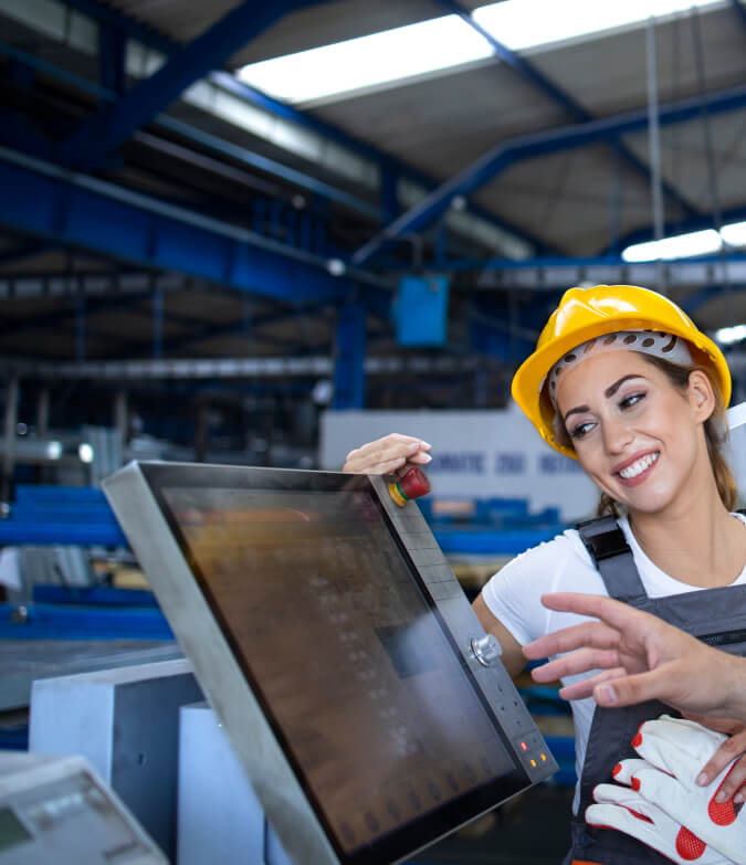 factory worker explaining how to operate industrial machine